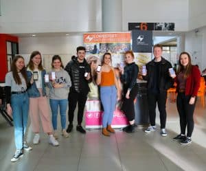 Group of students holding up their phones