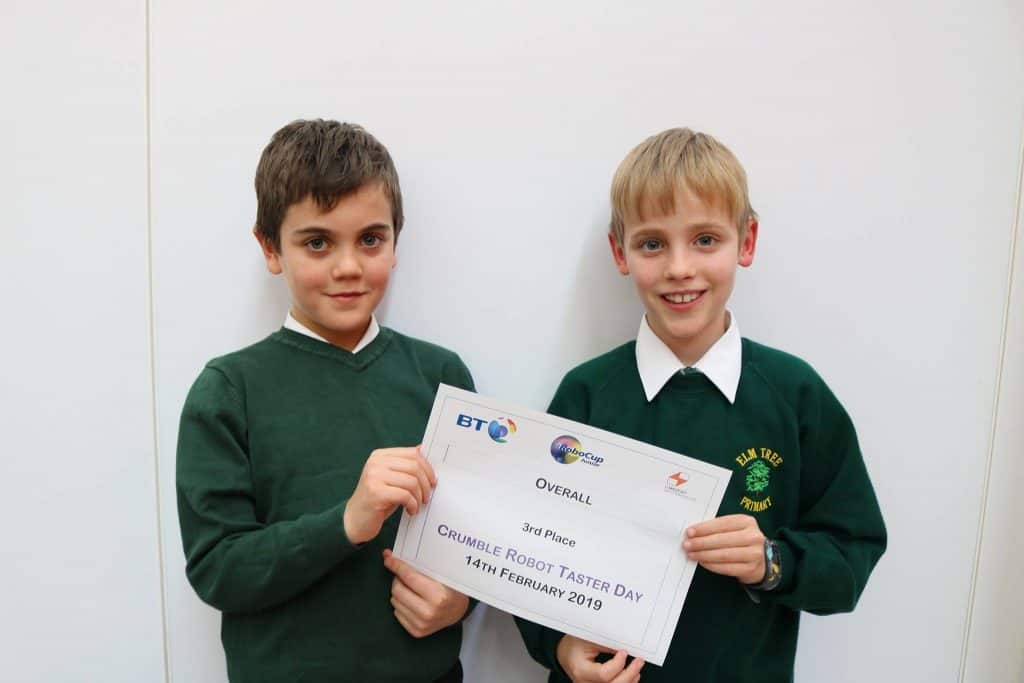 2 students holding up a 3rd place certificate