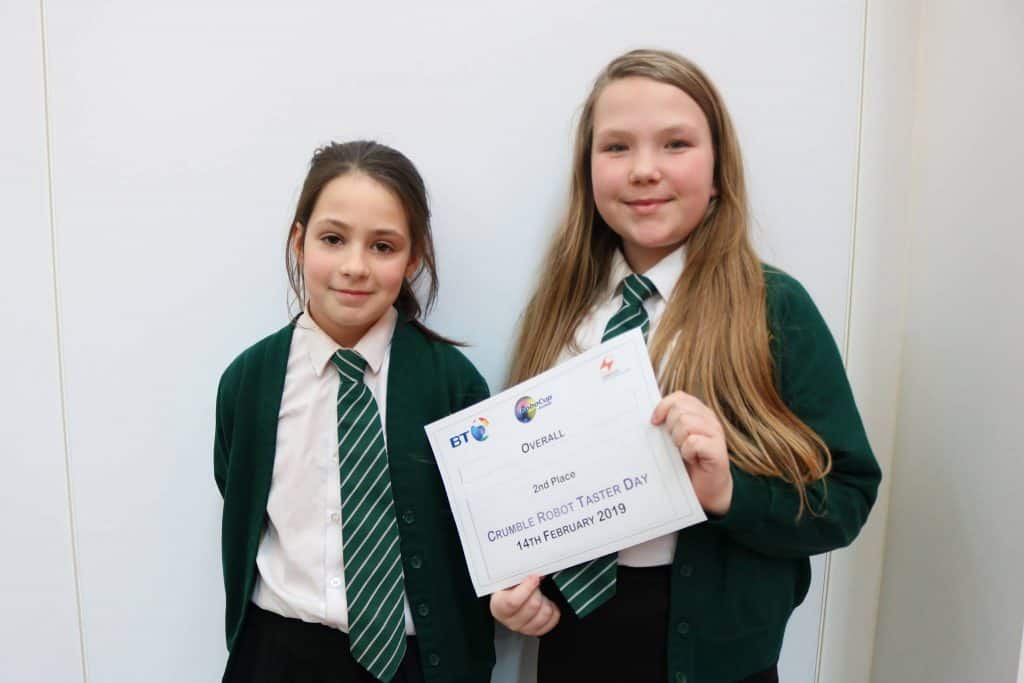 2 students holding up a 2nd place certificate