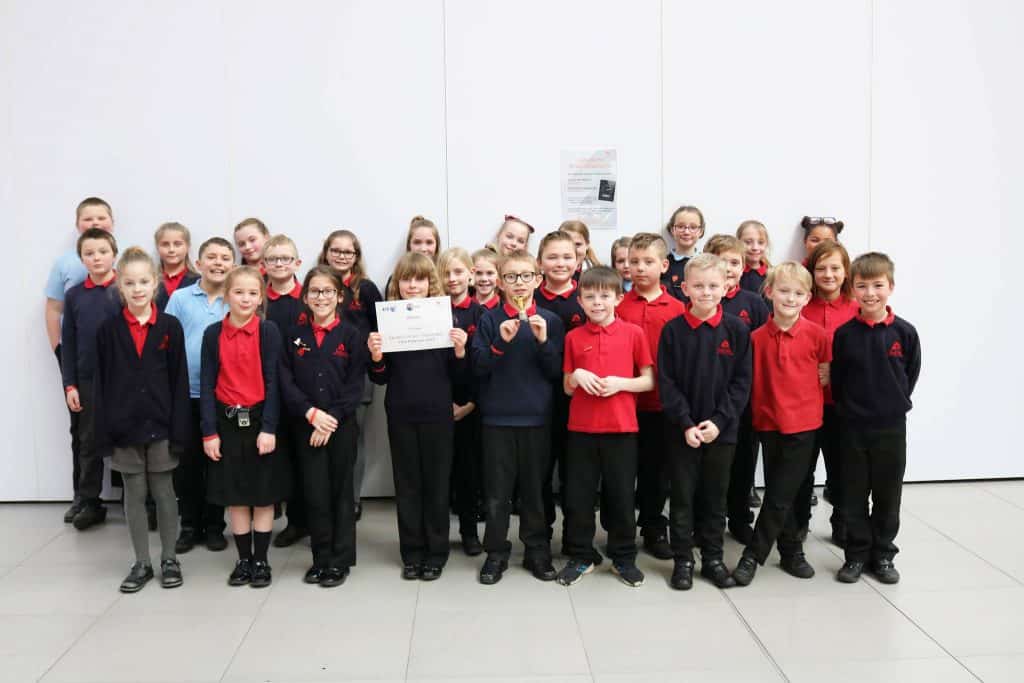 Group of students holding up a certificate