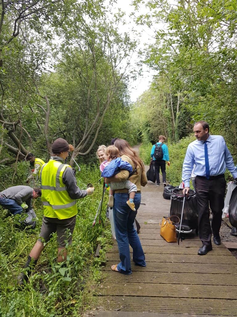 Various students and staff of the college collecting litter