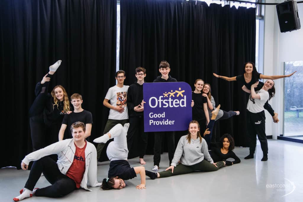 Various college students holding up an Ofsted Good Provider banner