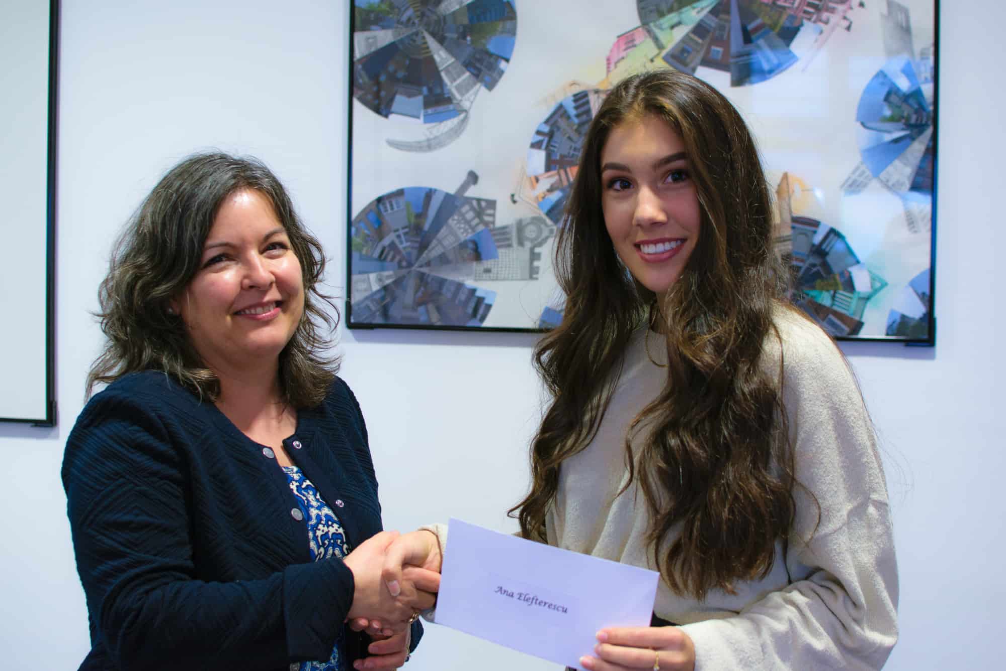 Student receiving scholarship cheque