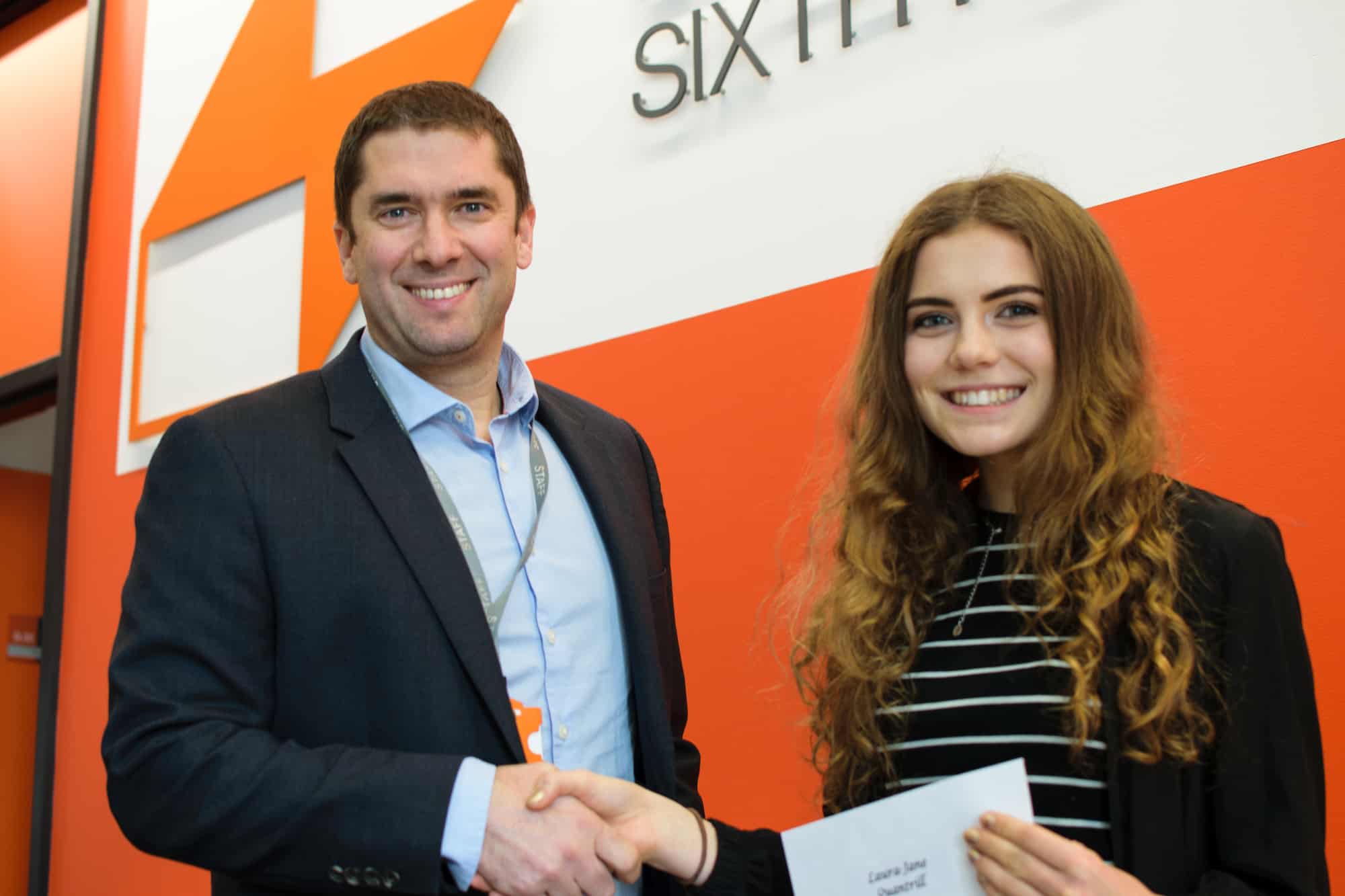 Student receiving scholarship cheque